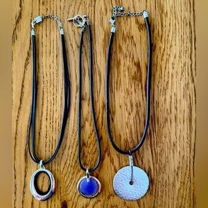 Three pendant necklaces.